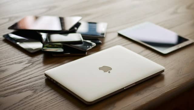 A laptop next to a collection of mobile devices